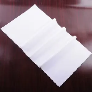 Close-up detail showing the texture and scalloped edges of a thickened white microfiber towel