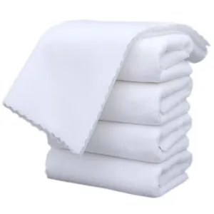 Detailed view of four stacked white microfiber towels showing soft texture and scalloped edges