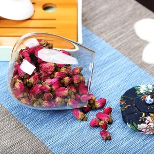 Elegante bote de té de vidrio de borosilicato con tapa de tela floral para capullos rosas