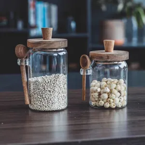 Close-up of high borosilicate glass seasoning jars with wooden lids and spoons