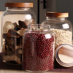 Grand pot de stockage en verre transparent avec couvercle en bois pour cuisine, thé et grains.