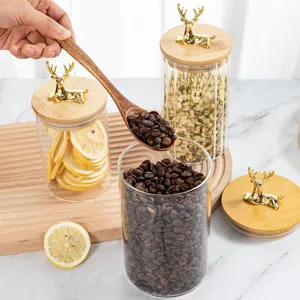 Elegant glass storage jars with golden elk lids and vertical striped design for kitchen
