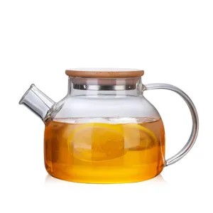 Clear high borosilicate glass cold water pitcher with bamboo lid and fresh lemon tea