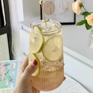 Minimalist transparent striped high borosilicate glass cup filled with cold lime drink