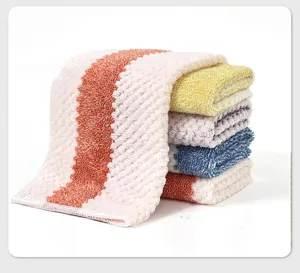 Close-up detail of soft coral fleece microfibre kitchen towels with absorbent texture