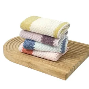 Set of four ultra-absorbent coral fleece kitchen dishcloths displayed on a wooden tray