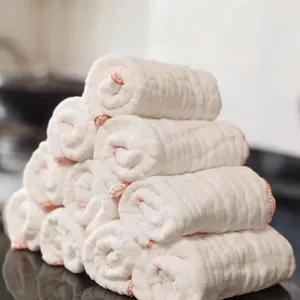 Premium stacked white pure cotton gauze dishcloths with decorative red stitched edges