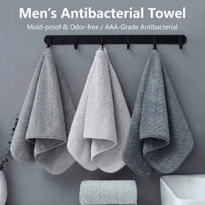 Detail of soft men's coral fleece towels with wheat ear pattern hanging in bathroom