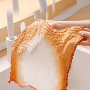 Thickened cotton gauze dishcloth being washed under faucet, highly absorbent kitchen towel