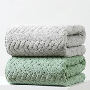 Close-up of stacked plush bath towels with textured herringbone pattern in pack of 2.