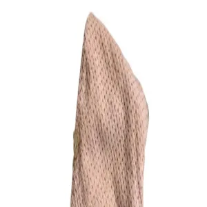 Detailed macro view of pink waffle texture on an absorbent hair drying cap with a button