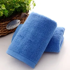 Close-up showing the soft terry cloth texture of a blue 100% cotton square washcloth.