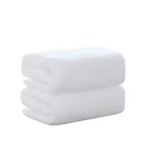 Set of two soft white 100% cotton bath towels suitable for professional hotel and salon use