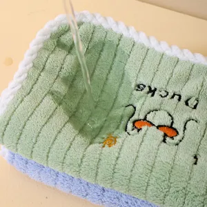 Detailed view of absorbent coral fleece towel showing soft texture and duck embroidery.