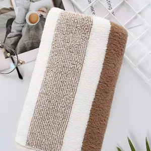 Close-up detail of soft and thick absorbent coral fleece striped towel texture