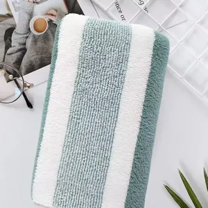 Macro detail of ultra soft thick mint green and white striped coral fleece towel texture