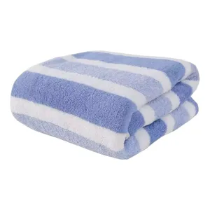 Soft thickened blue and white striped coral fleece bath towel on white background