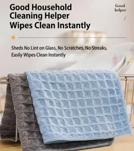 Detailed view of grey and blue waffle weave cleaning cloths on a kitchen rack