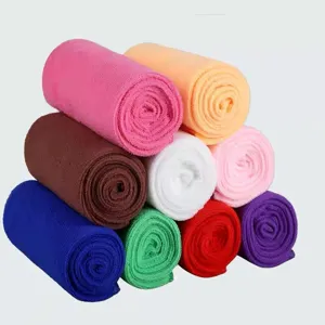 Assorted colors of rolled microfiber absorbent cleaning towels stacked together.