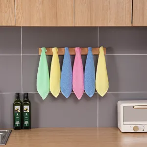 Detailed view of colorful wood fiber cleaning cloths hanging in a modern kitchen
