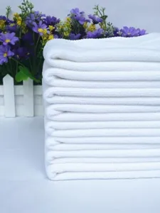 Macro detail of stacked white disposable fiber towels for dust-free industrial cleaning