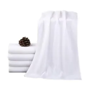 Close-up of premium soft white absorbent towels for hotel or salon use with pinecone