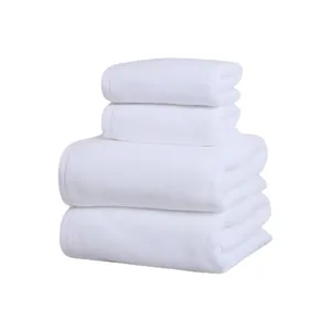 Four-piece stack of premium thick white cotton bath towels for hotel and home spa use