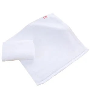 Macro view of soft white cotton square towels for hotel and restaurant use, 100% cotton material.