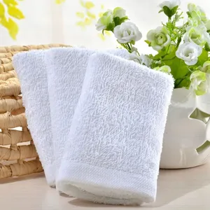 Close-up detail of three premium soft white cotton towels for hotel, spa, and home use