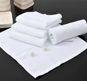 Close-up of premium white cotton square towels showing soft absorbent texture