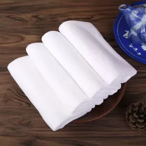 Stack of soft white microfiber square towels for professional hotels and salons