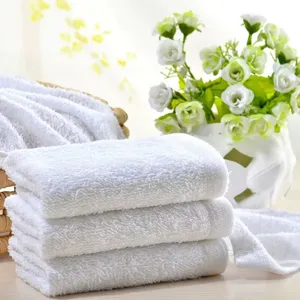 Close-up detail of soft white cotton towels with fluffy Terry texture in spa setting