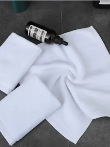 Detailopname van witte katoenen vierkante handdoekjes met zachte badstof textuur