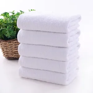 Stack of five soft white pure cotton towels for luxury hotel and bathroom use