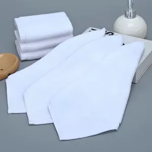 Set of white pure cotton washcloths with soft texture presented on a grey background