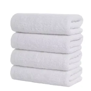 Soft and absorbent stack of four premium white cotton towels for hotel and spa use