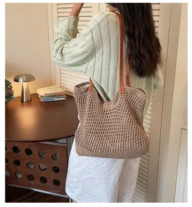 Detailed shot of a hollow-out woven cotton thread tote bag carried on shoulder