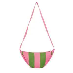 Detailed view of the striped pattern on a knitted crescent-shaped crossbody bag