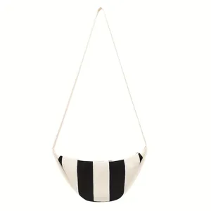 Detailed view of lightweight woven striped crossbody bag in black and beige tones