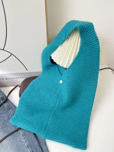 Close-up of teal knitted tote bag with woven texture in a lifestyle setting