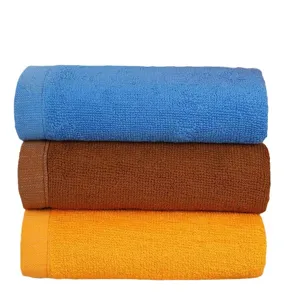Stack of three soft and thick absorbent cotton towels in blue, brown, and orange