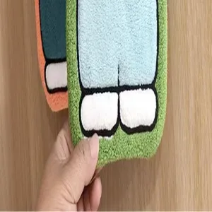 Close-up of soft cartoon coral fleece hand towel showing character leg details