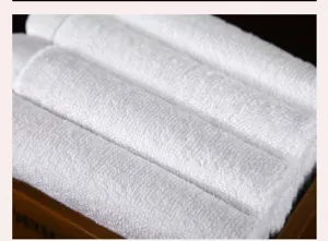 Macro view of soft white cotton towels with absorbent fabric texture