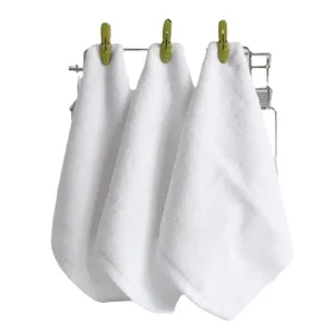 Set of three thick white cotton square towels hanging for professional facial hot compress