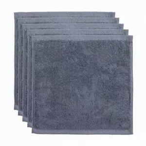 Detailed view of six stacked blue cotton washcloths with soft looped texture.