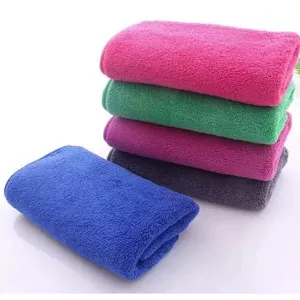 Pack of colorful thick coral fleece absorbent cleaning towels for professional kitchen use
