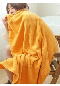 Detailed macro view showing the soft vertical striped texture of yellow coral fleece bath towel