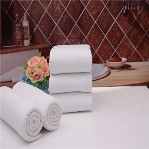 Detailed close-up of plush white cotton bath towels showing soft absorbent texture