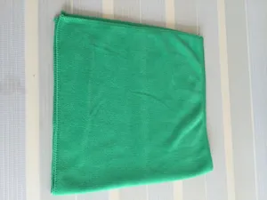 Close-up view of a bright green soft and absorbent microfiber towel with fine fabric texture