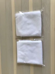 Pack of two individually wrapped disposable white towels for hotel and spa use